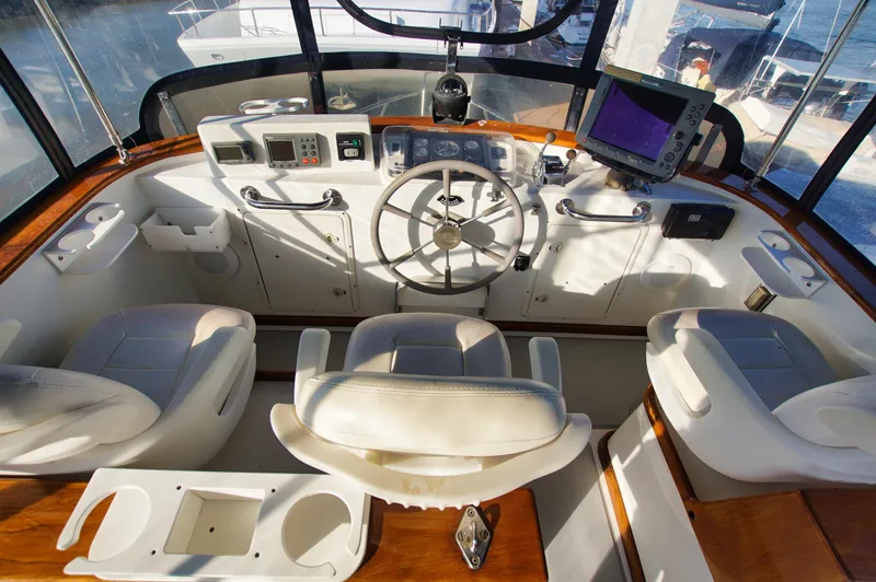 Funky Monkey Yacht Photos Pics Helm of 2001 Monk 36 boat with steering wheel, navigation equipment, and seating.