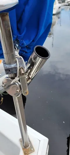 Funky Monkey Yacht Photos Pics Stainless steel rod holder on a 2001 Monk 36 boat, docked by the water.
