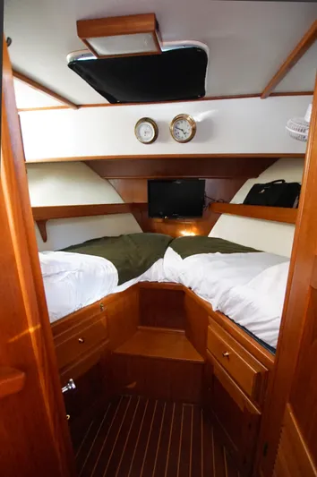 Funky Monkey Yacht Photos Pics Cozy cabin interior of 2001 Monk 36 boat with twin beds and wooden finish.