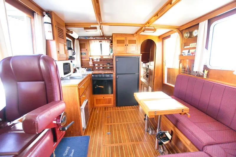 Funky Monkey Yacht Photos Pics Interior of 2001 Monk 36 boat with kitchen, seating, and wooden finishes.