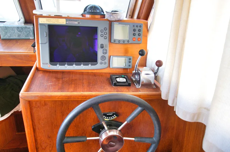 Funky Monkey Yacht Photos Pics Helm station of 2001 Monk 36 boat with navigation equipment and steering wheel.