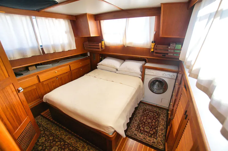 Funky Monkey Yacht Photos Pics Cozy cabin interior of 2001 Monk 36 yacht with bed and washing machine.