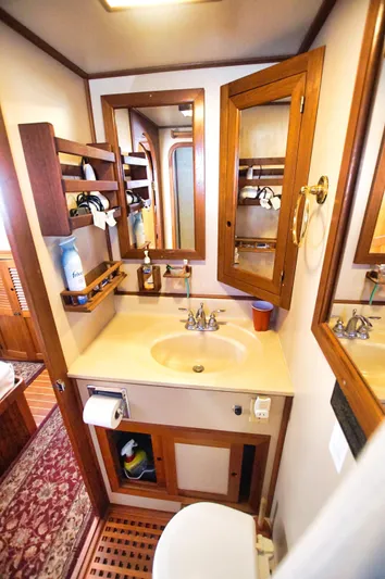 Funky Monkey Yacht Photos Pics Bathroom interior of 2001 Monk 36 boat, featuring wooden cabinetry and sink.