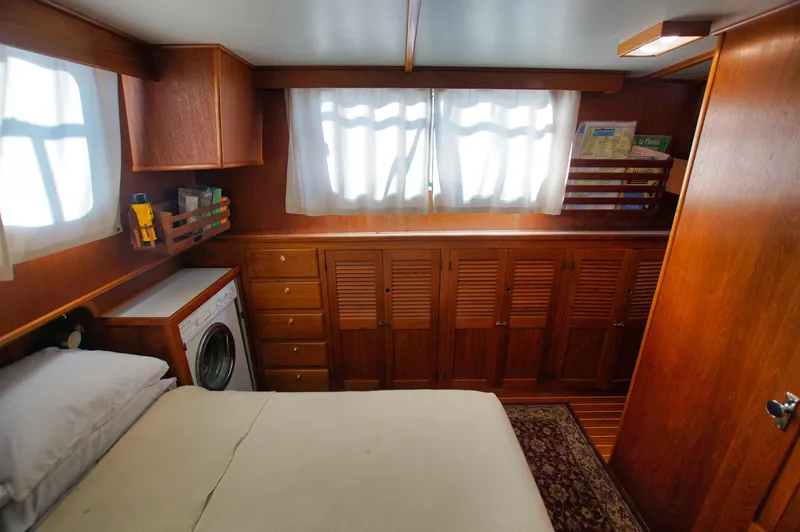 Funky Monkey Yacht Photos Pics Cozy cabin interior of 2001 Monk 36 boat with wood paneling and built-in storage.