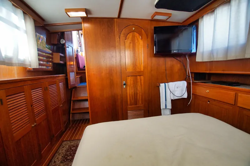 Funky Monkey Yacht Photos Pics Interior of 2001 Monk 36 boat, featuring wood paneling, TV, and cozy cabin space.