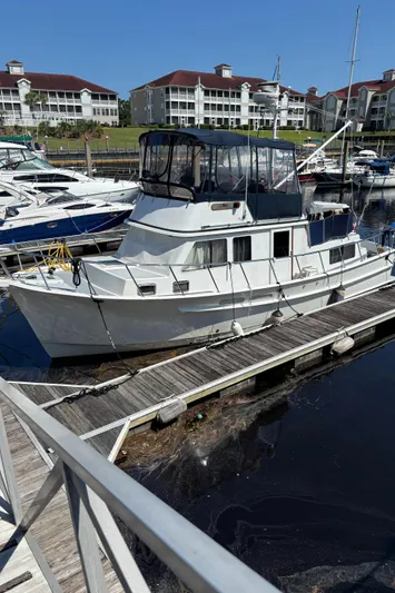 Funky Monkey Yacht Photos Pics White 2001 Monk 36 (Hull #215) docked at marina with waterfront buildings in background.
