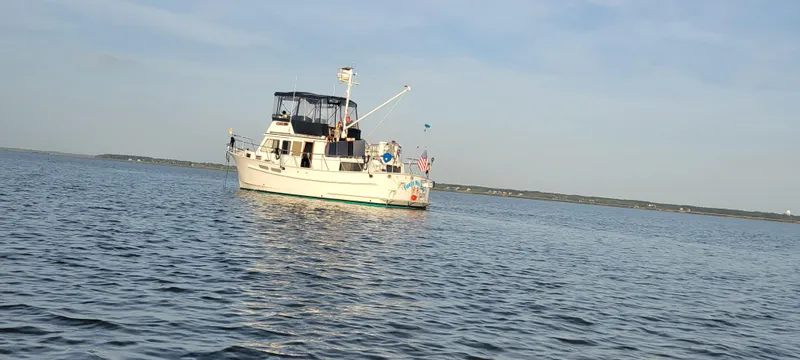 Funky Monkey Yacht Photos Pics A 2001 Monk 36 yacht on calm waters under a clear sky.