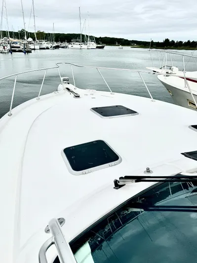  Yacht Photos Pics 2007 Tiara Yachts 3600 Open on calm water, docked with other boats.