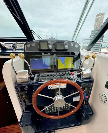  Yacht Photos Pics 2007 Tiara Yachts 3600 Open helm with navigation screens and wooden steering wheel.