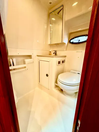  Yacht Photos Pics 2007 Tiara Yachts 3600 Open bathroom with toilet, sink, and storage cabinet.