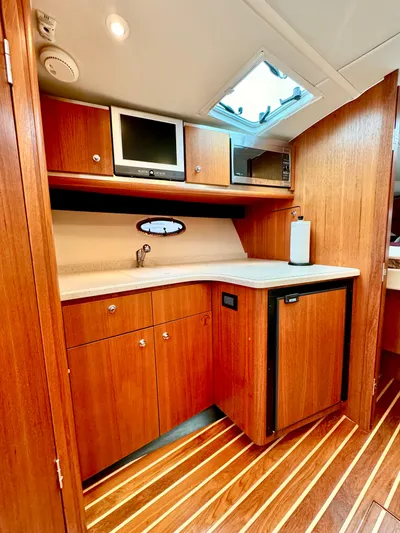  Yacht Photos Pics 2007 Tiara Yachts 3600 Open galley with wood cabinetry, compact appliances, and sleek design.
