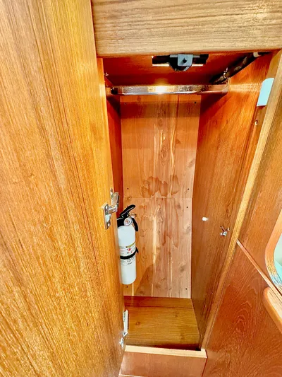  Yacht Photos Pics 2007 Tiara Yachts 3600 Open wooden cabinet interior with fire extinguisher.