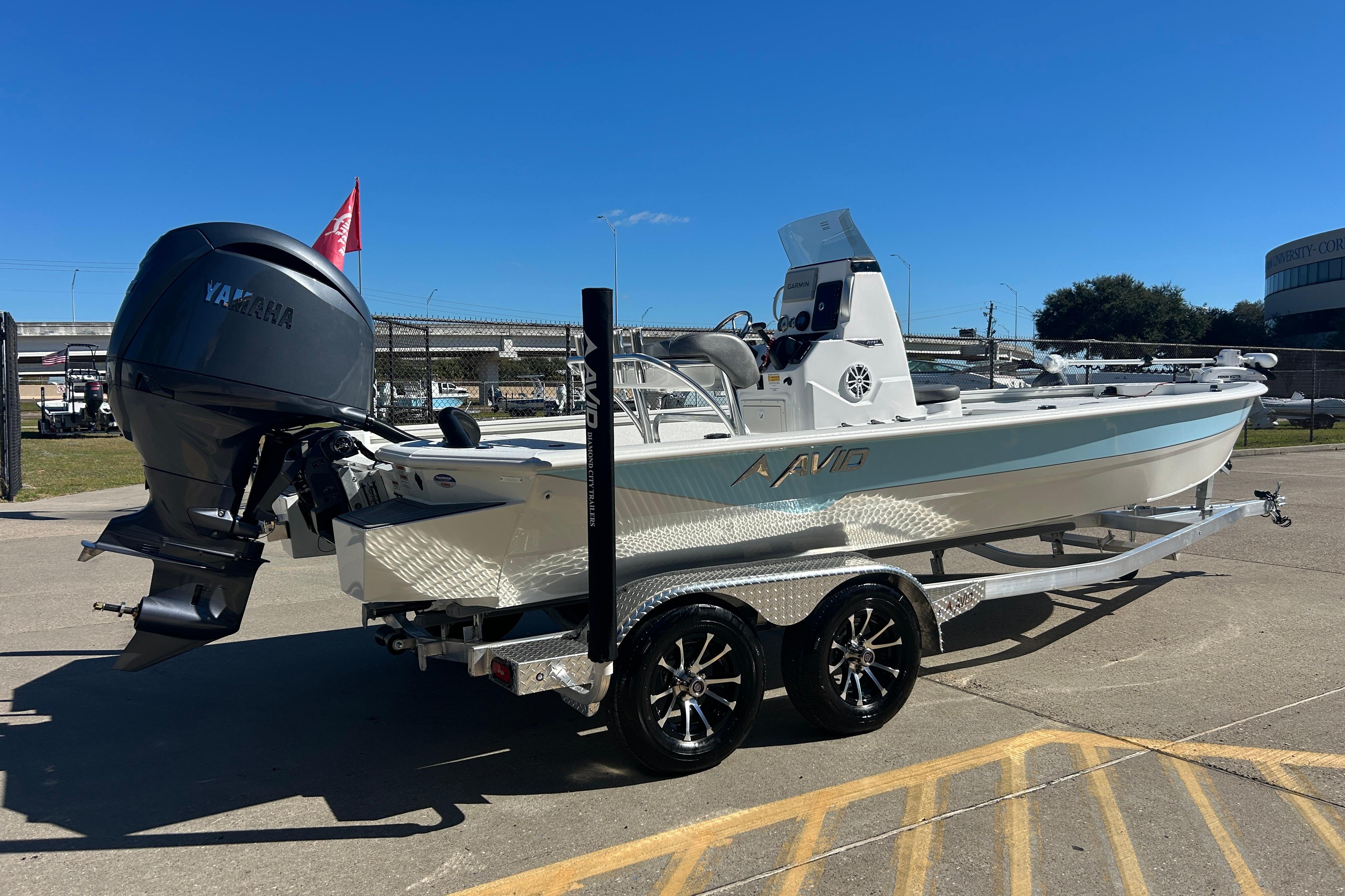2025 Avid 21 FST boat with Yamaha engine on a trailer, parked outdoors.