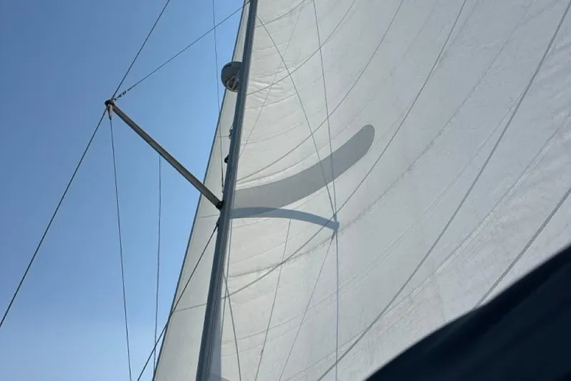 Free Range Yacht Photos Pics Sail of a 2005 Hunter 44 yacht against a clear blue sky.