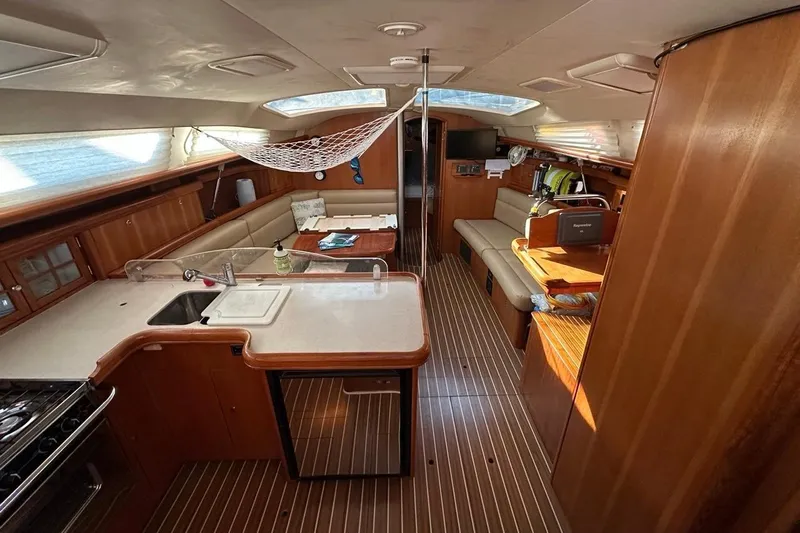 Free Range Yacht Photos Pics Interior of 2005 Hunter 44 sailboat with kitchen, seating, and wooden finishes.