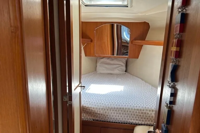 Free Range Yacht Photos Pics Cozy cabin interior of 2005 Hunter 44 sailboat with wooden finish and bed.