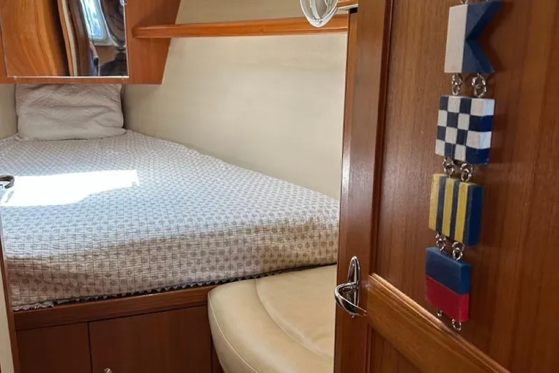 Free Range Yacht Photos Pics Cozy cabin interior of 2005 Hunter 44 sailboat with bed and nautical decor.