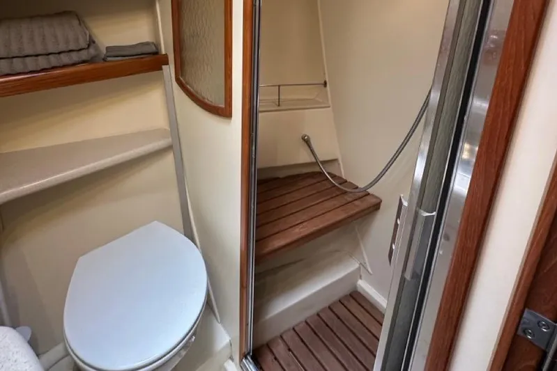 Free Range Yacht Photos Pics 2005 Hunter 44 yacht bathroom with shower, toilet, and wooden accents.