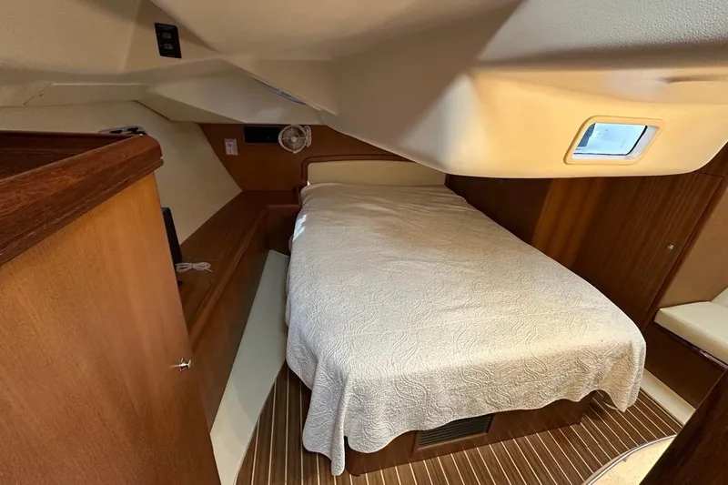 Free Range Yacht Photos Pics Cozy cabin interior of 2005 Hunter 44 sailboat with bed and wooden accents.