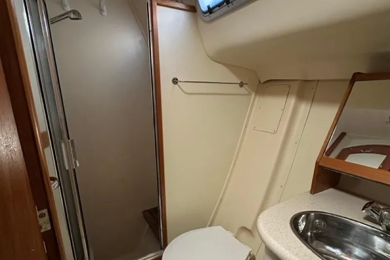 Free Range Yacht Photos Pics Bathroom interior of a 2005 Hunter 44 yacht, featuring a shower and sink.