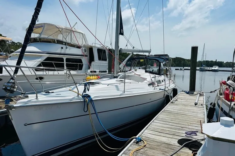 Free Range Yacht Photos Pics 2005 Hunter 44 sailboat docked at marina, surrounded by other boats.