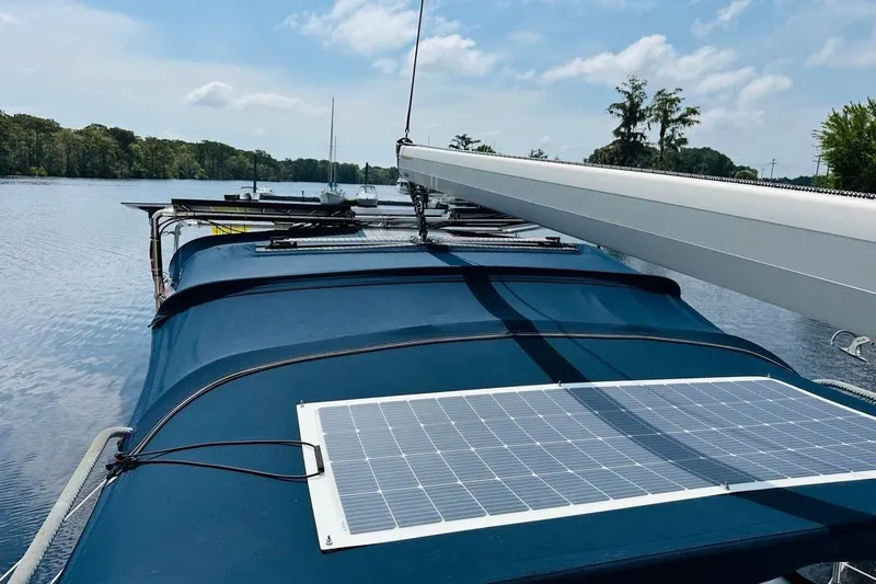 Free Range Yacht Photos Pics Sailboat with solar panel on deck, Hunter 44 model, 2005, on a calm lake.