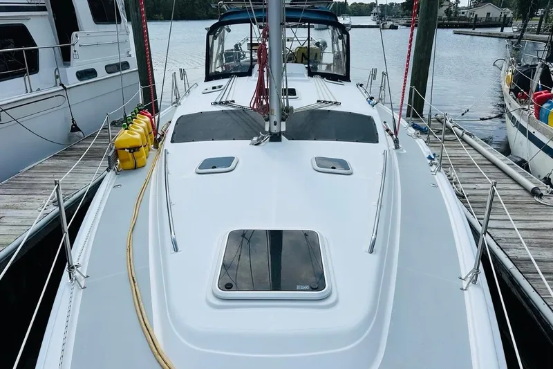 Free Range Yacht Photos Pics 2005 Hunter 44 sailboat docked, featuring a clean deck and moored alongside other boats.