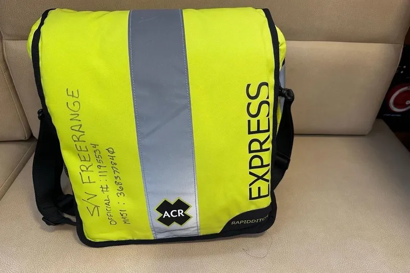 Free Range Yacht Photos Pics Yellow ACR Express bag on Hunter 44, 2005 model, with reflective strip and handwritten details.