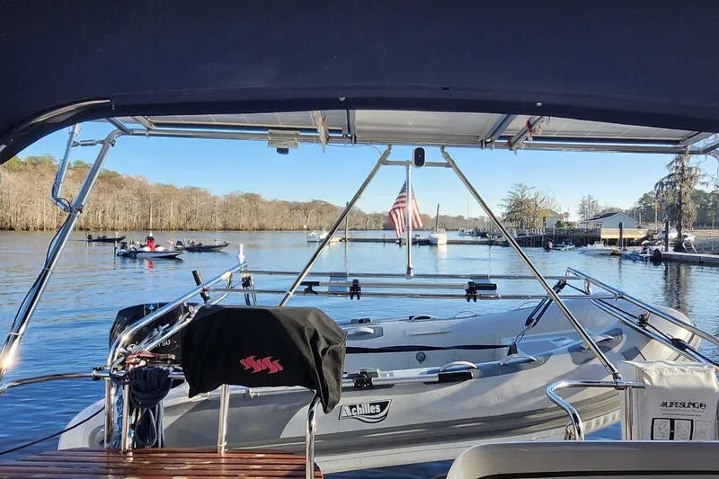 Free Range Yacht Photos Pics Hunter 44 sailboat from 2005 docked, with American flag and scenic waterfront view.