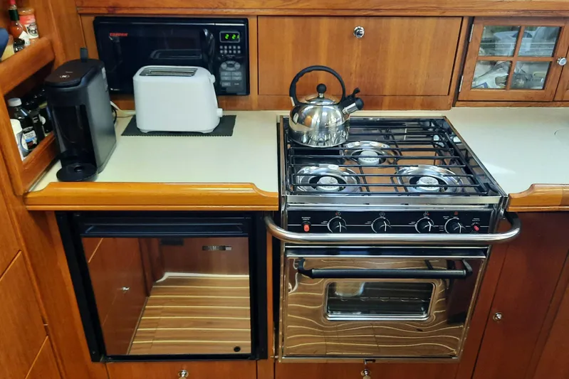 Free Range Yacht Photos Pics Compact kitchen in a 2005 Hunter 44 yacht with stove, microwave, and appliances.