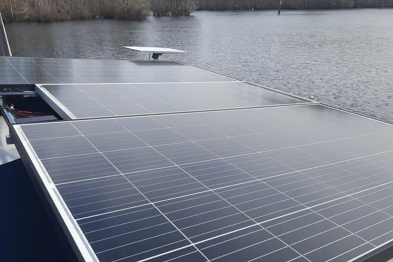 Free Range Yacht Photos Pics Solar panels on a 2005 Hunter 44 boat by a lake.