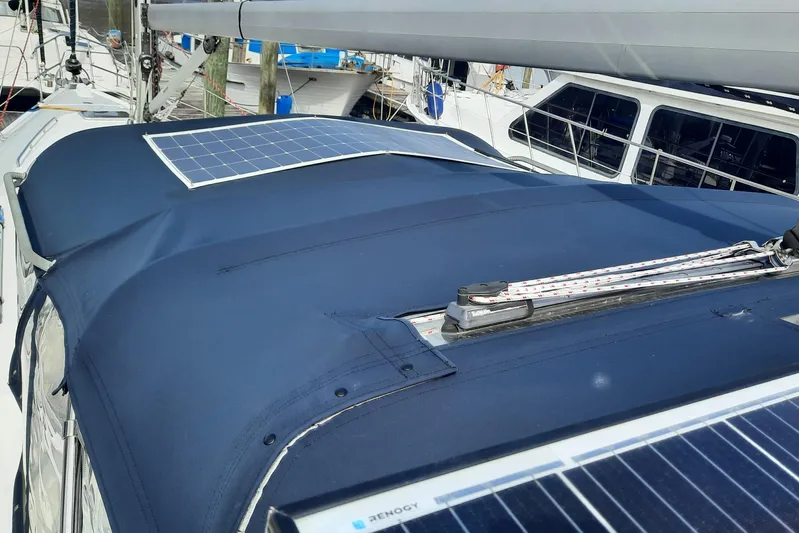 Free Range Yacht Photos Pics 2005 Hunter 44 sailboat with solar panels on deck, docked at marina.