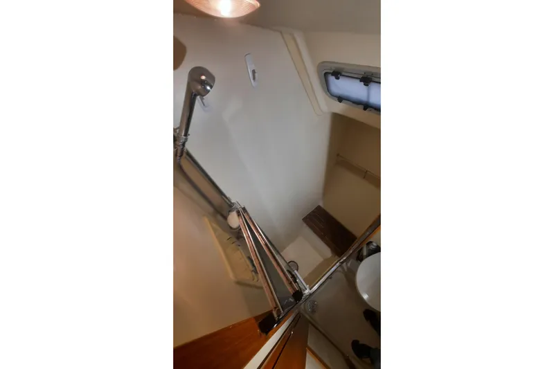 Free Range Yacht Photos Pics Bathroom interior of a 2005 Hunter 44 yacht with shower and porthole.