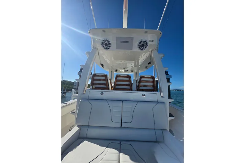  Yacht Photos Pics 2024 SeaVee 420Z boat interior with seating and electronics under clear blue sky.