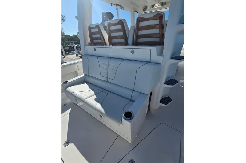  Yacht Photos Pics 2024 SeaVee 420Z boat seating area with cushioned seats and cup holders.