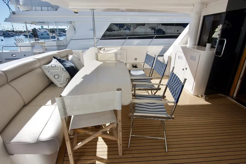 T.t. Amore Yacht Photos Pics Luxurious 2004 West Bay Cockpit Pilot House Motoryacht deck with seating and table.