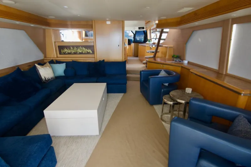 T.t. Amore Yacht Photos Pics Luxurious interior of 2004 West Bay Cockpit Pilot House Motoryacht with blue seating and modern decor.