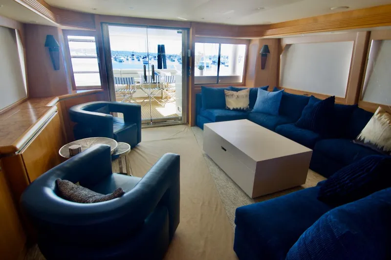 T.t. Amore Yacht Photos Pics Luxurious 2004 West Bay Cockpit Pilot House Motoryacht interior with blue seating and large windows.