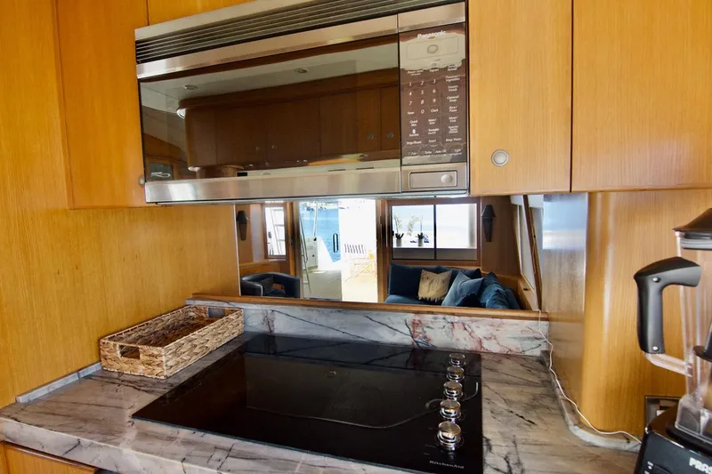 T.t. Amore Yacht Photos Pics Luxurious kitchen interior of 2004 West Bay Cockpit Pilot House Motoryacht with modern appliances.