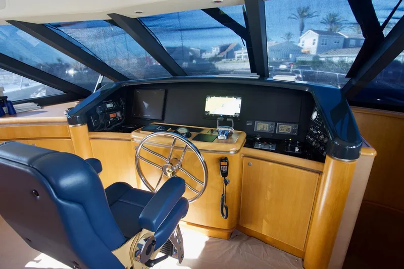 T.t. Amore Yacht Photos Pics 2004 West Bay Cockpit Pilot House Motoryacht helm with navigation equipment and steering wheel.