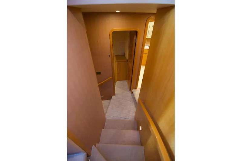 T.t. Amore Yacht Photos Pics 2004 West Bay Cockpit Pilot House Motoryacht interior staircase with wooden finish.