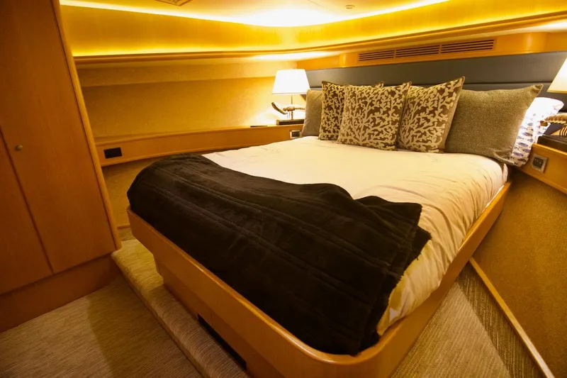 T.t. Amore Yacht Photos Pics Luxurious bedroom interior of 2004 West Bay Cockpit Pilot House Motoryacht with elegant bedding.