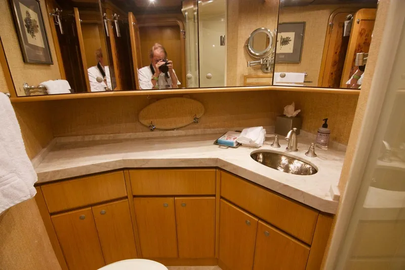 T.t. Amore Yacht Photos Pics Luxurious bathroom in 2004 West Bay Cockpit Pilot House Motoryacht with elegant fixtures and wood cabinetry.