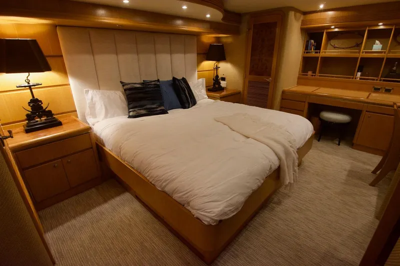 T.t. Amore Yacht Photos Pics Luxurious bedroom in 2004 West Bay Cockpit Pilot House Motoryacht, featuring elegant wood furnishings.