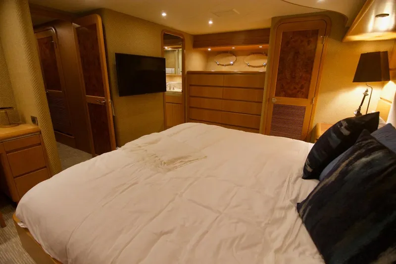 T.t. Amore Yacht Photos Pics Luxurious bedroom interior of 2004 West Bay Cockpit Pilot House Motoryacht with elegant wood finishes.