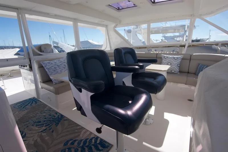 T.t. Amore Yacht Photos Pics Luxurious 2004 West Bay Cockpit Pilot House Motoryacht interior with plush seating and panoramic windows.