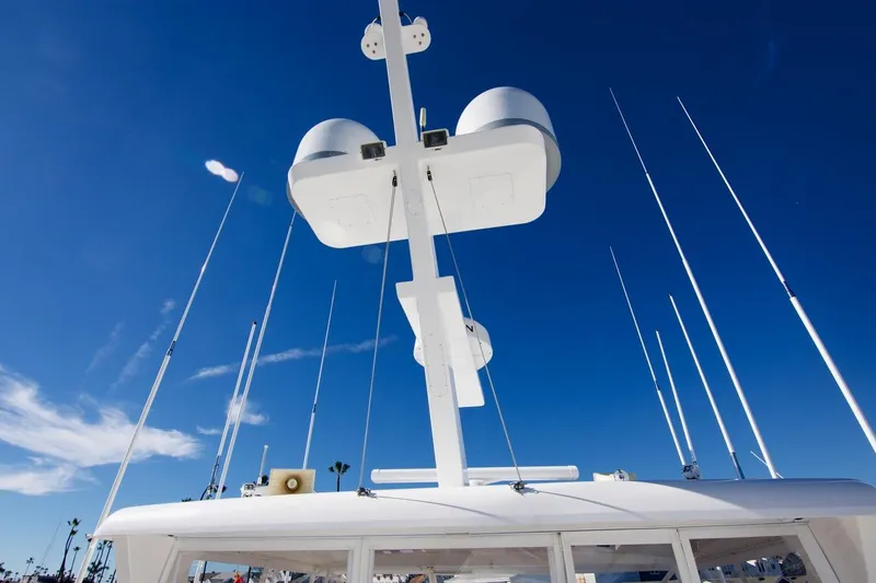 T.t. Amore Yacht Photos Pics 2004 West Bay Cockpit Pilot House Motoryacht antennas against clear blue sky.