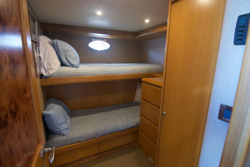 T.t. Amore Yacht Photos Pics 2004 West Bay Cockpit Pilot House Motoryacht cabin with wooden bunk beds and storage.