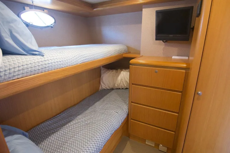 T.t. Amore Yacht Photos Pics 2004 West Bay Cockpit Pilot House Motoryacht cabin with bunk beds and wooden cabinetry.