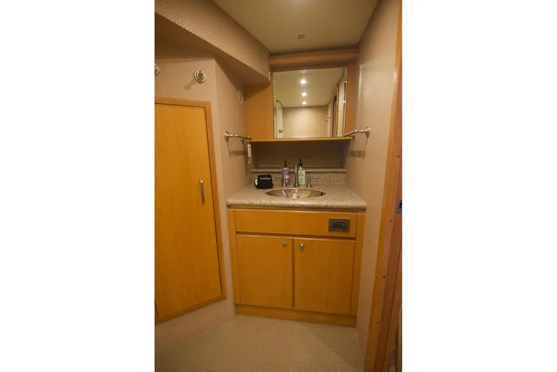 T.t. Amore Yacht Photos Pics Luxurious bathroom in 2004 West Bay Cockpit Pilot House Motoryacht with wooden cabinetry and modern fixtures.